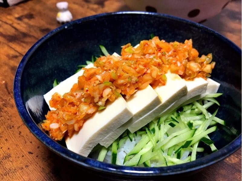 木綿豆腐ときゅうりをごはんにのせ、キムチねぎ塩だれをかけた火を使わない冷やっこ丼